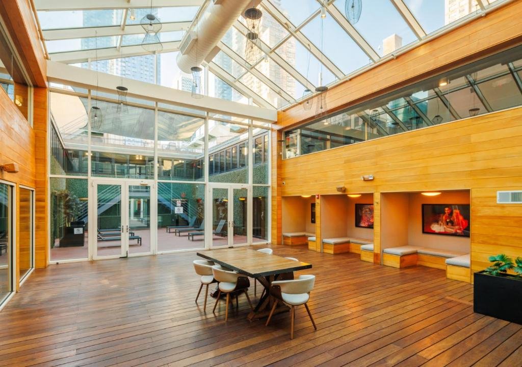 Indoor atrium with wood floor and glass ceiling