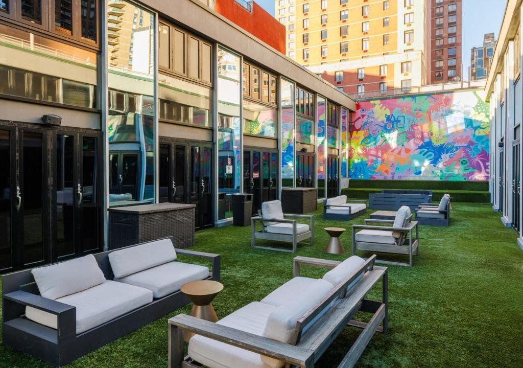 Outdoor lounge area with seating and mural wall