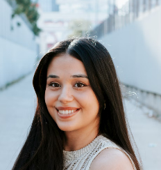 a smiling girl in a white shirt